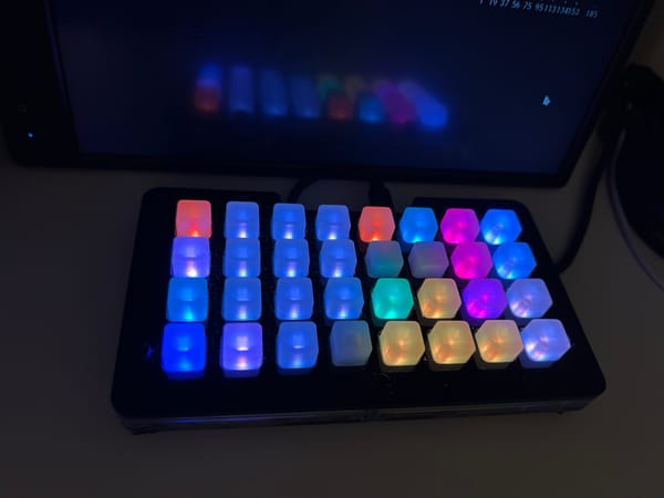 An Adafruit Neotrellis with it's led buttons illuminated to indicate buttons.